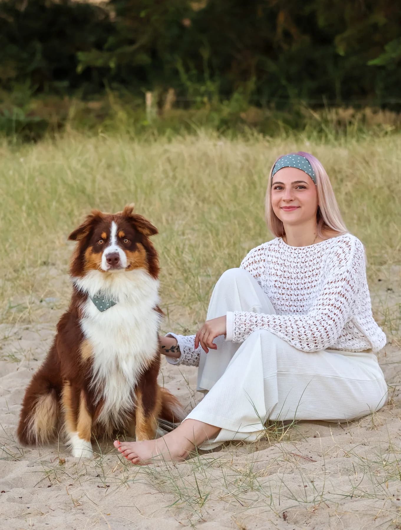 Créatrice portant un bandeau assorti au bandana de son chien dans les dunes